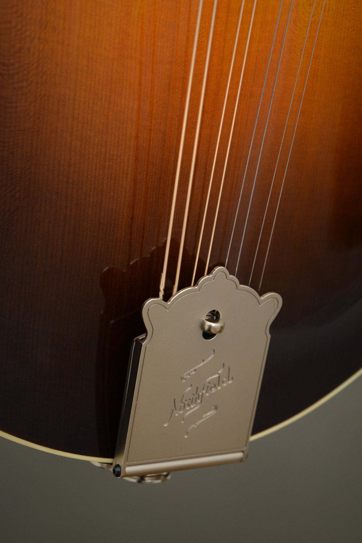 Engraved Northfield tailpiece on the Big Mon mandolin's lower top