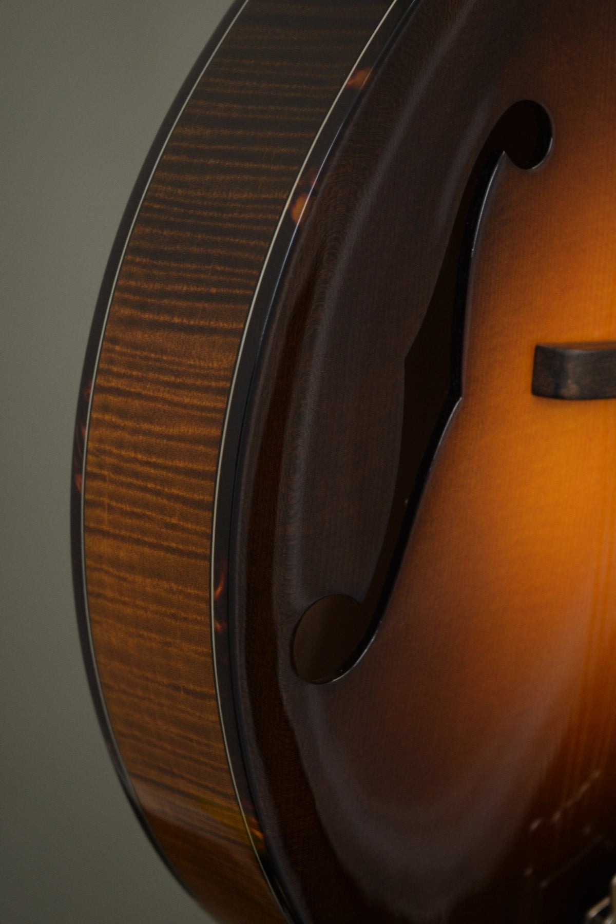 Flame maple rim, tortoise binding, and f-hole detail on the Big Mon mandolin