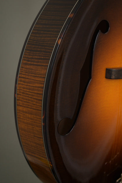 Flame maple rim, tortoise binding, and f-hole detail on the Big Mon mandolin