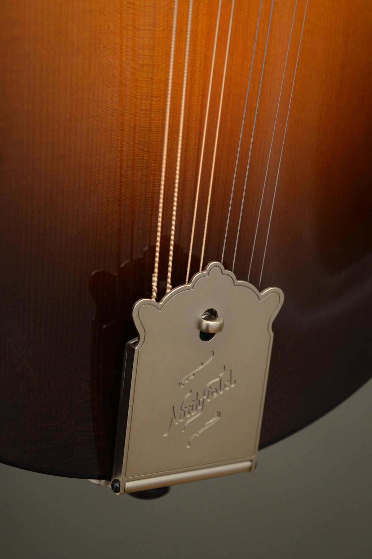 Engraved Northfield tailpiece on the Big Mon mandolin's lower top