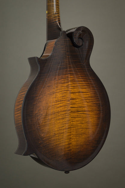 Flame maple back of the Big Mon mandolin, angled view with the scroll