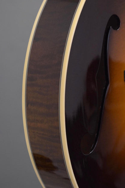 Flame maple rim and f-hole detail on the Big Mon mandolin's upper bout