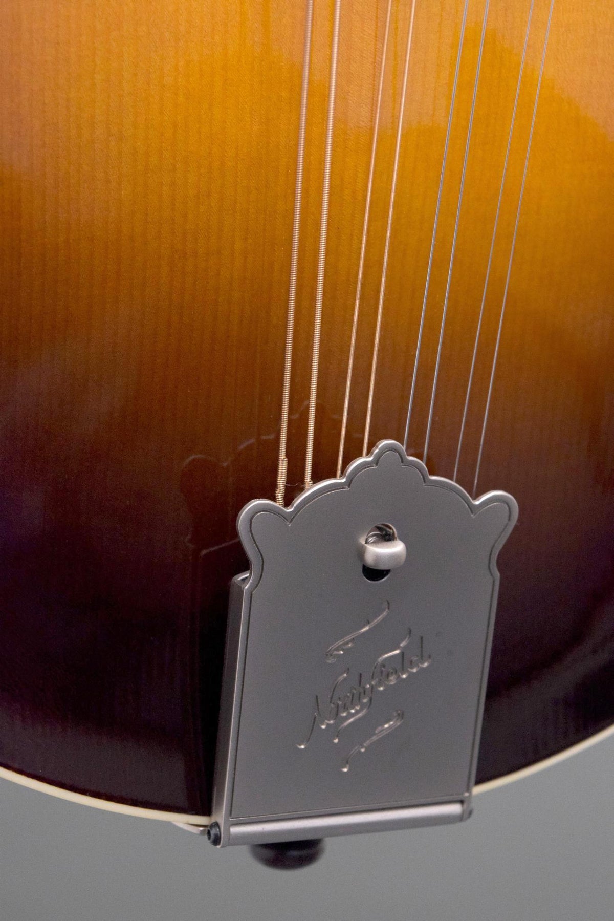 Engraved Northfield tailpiece and lower top of the Big Mon mandolin