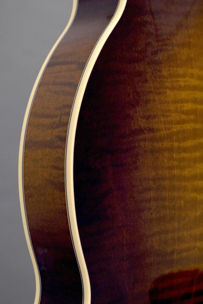 Flame maple rim and binding along the Big Mon mandolin's body curve
