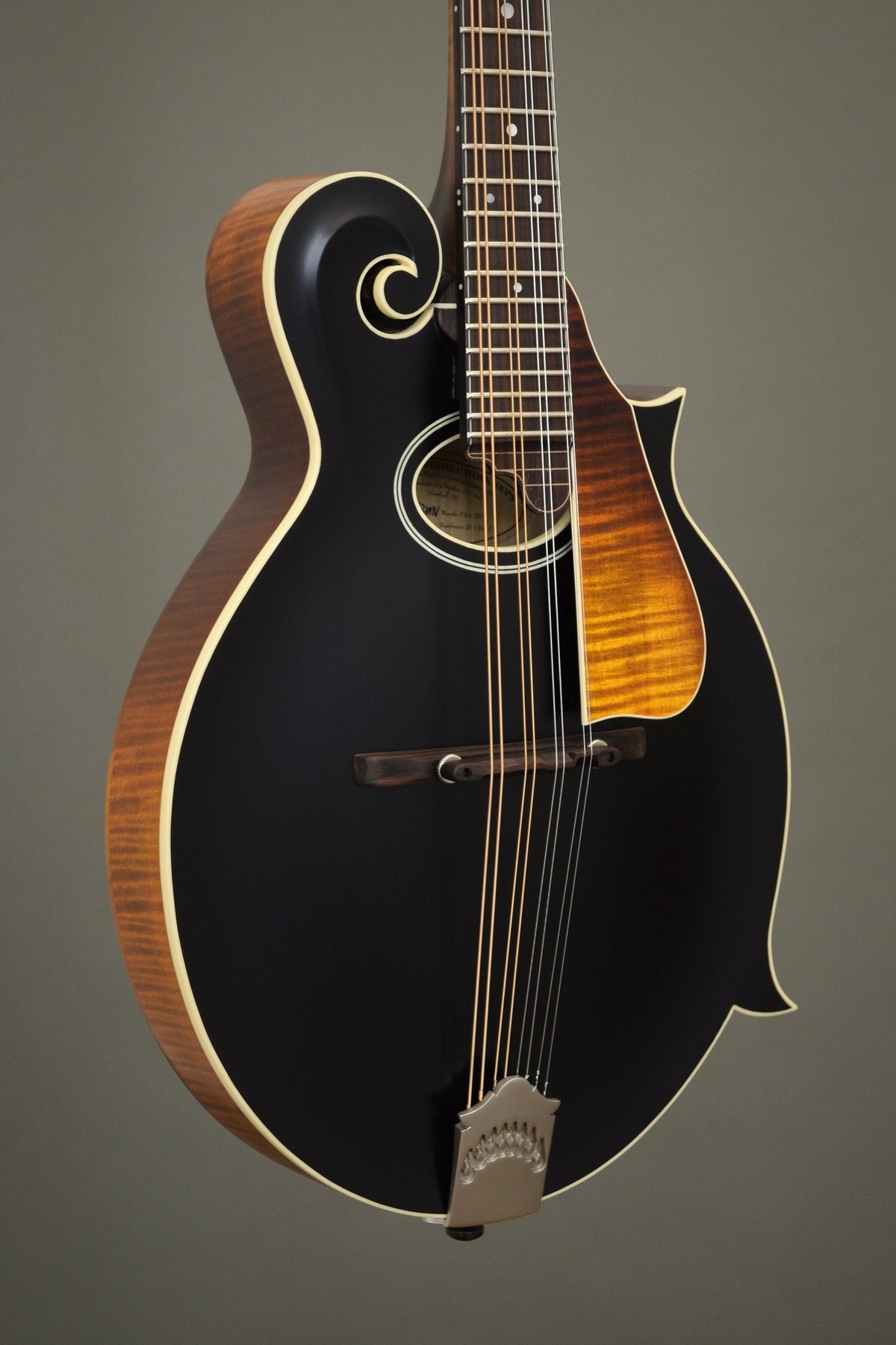 Northfield F2S oval hole mandolin with black top and flame maple pickguard, angled front view