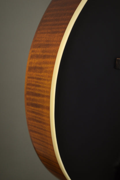Flame maple rim and ivoroid binding along the F2S mandolin's black top edge