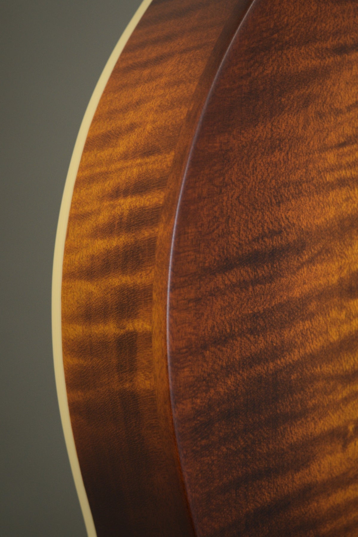 Flame maple rim and binding along the F2S mandolin's body curve