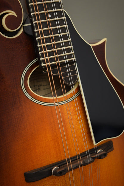 Oval sound hole, fingerboard extension, and ebony bridge on the F2S mandolin