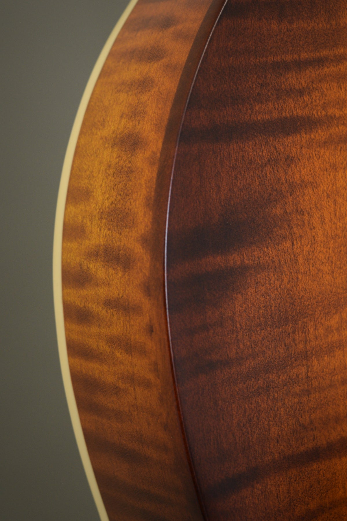 Flame maple rim and binding along the F2S mandolin's body curve